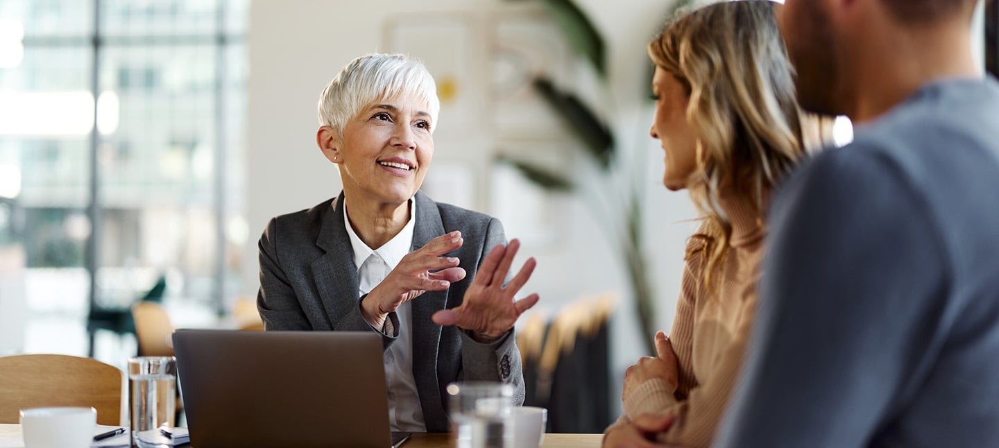 Professional women talking with couple