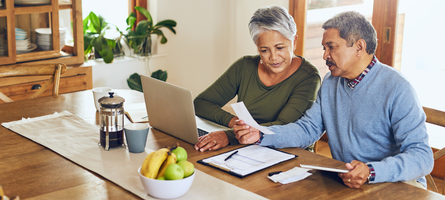 Shot of a mature couple managing their paperwork together at home