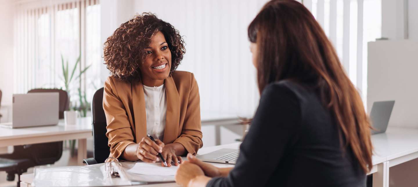 African American middle age women in a bank smiling