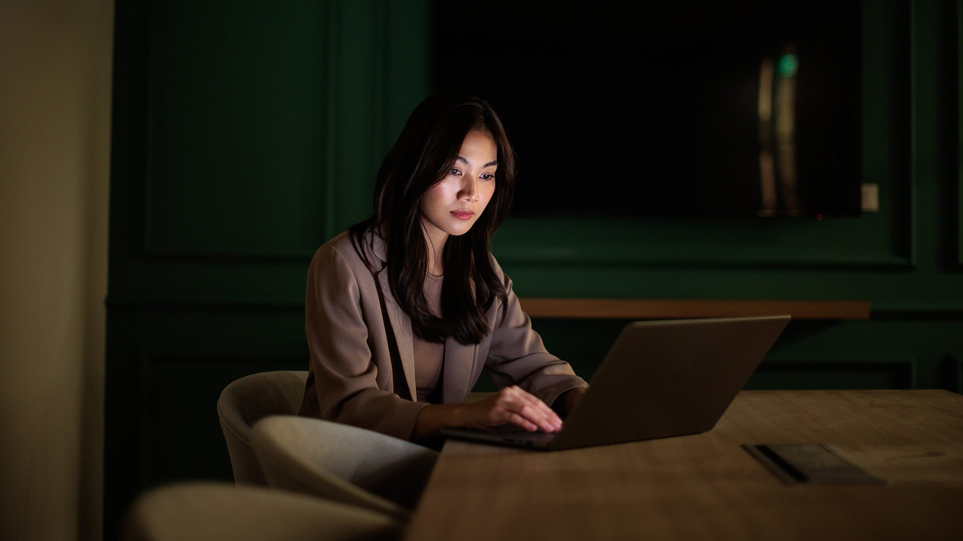 A woman sitting in her home using her laptop