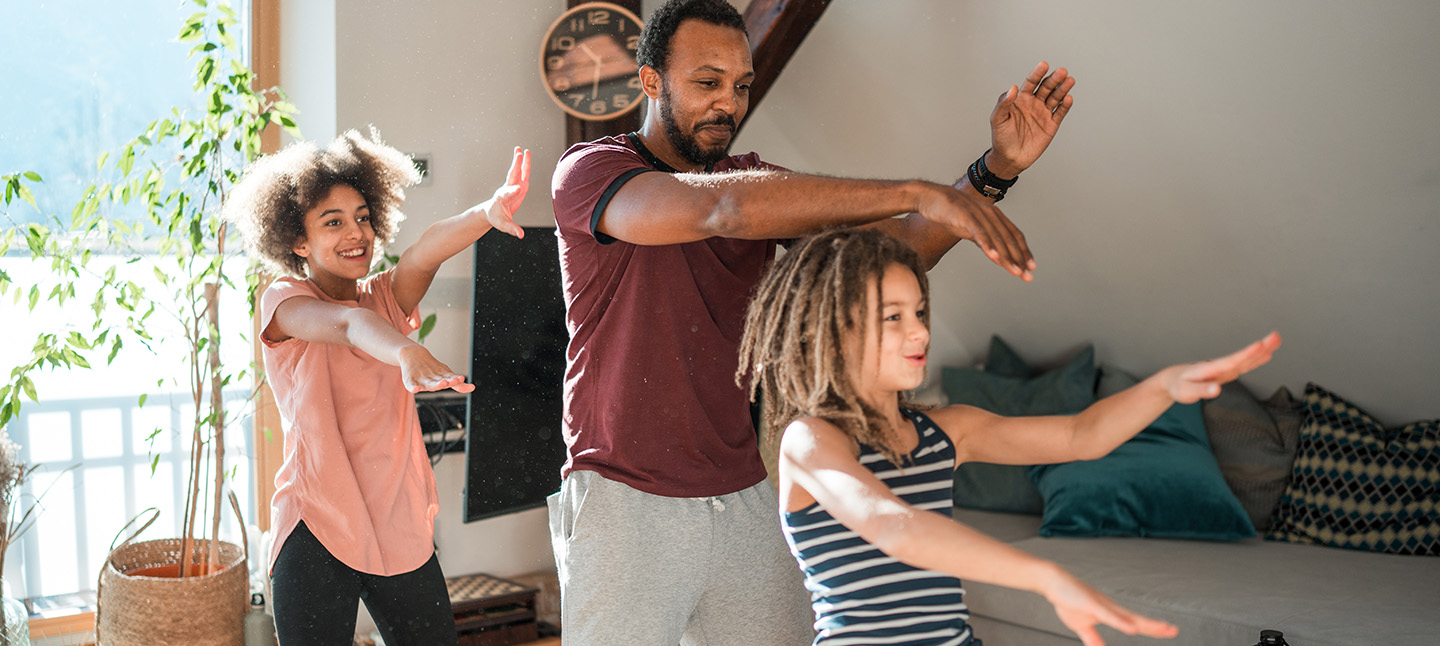 Family enjoying playful dance together indoors