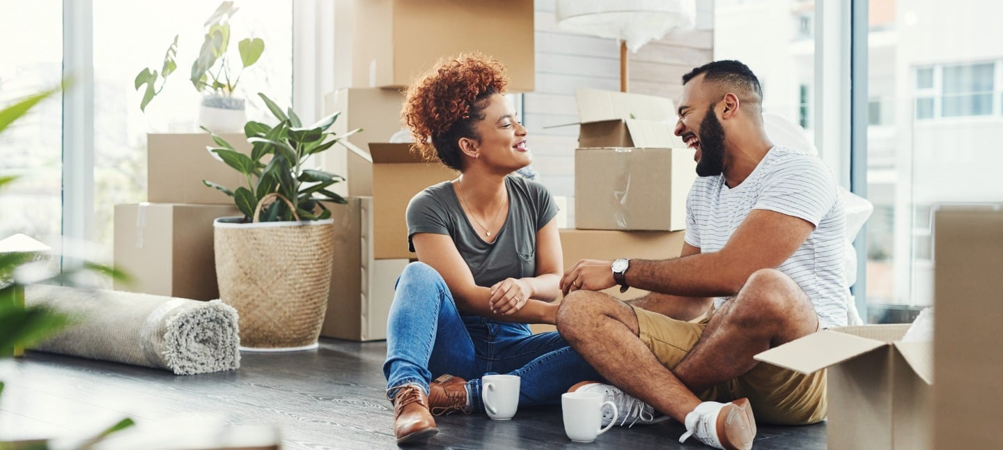 Young couple taking a break while moving into their new home.
