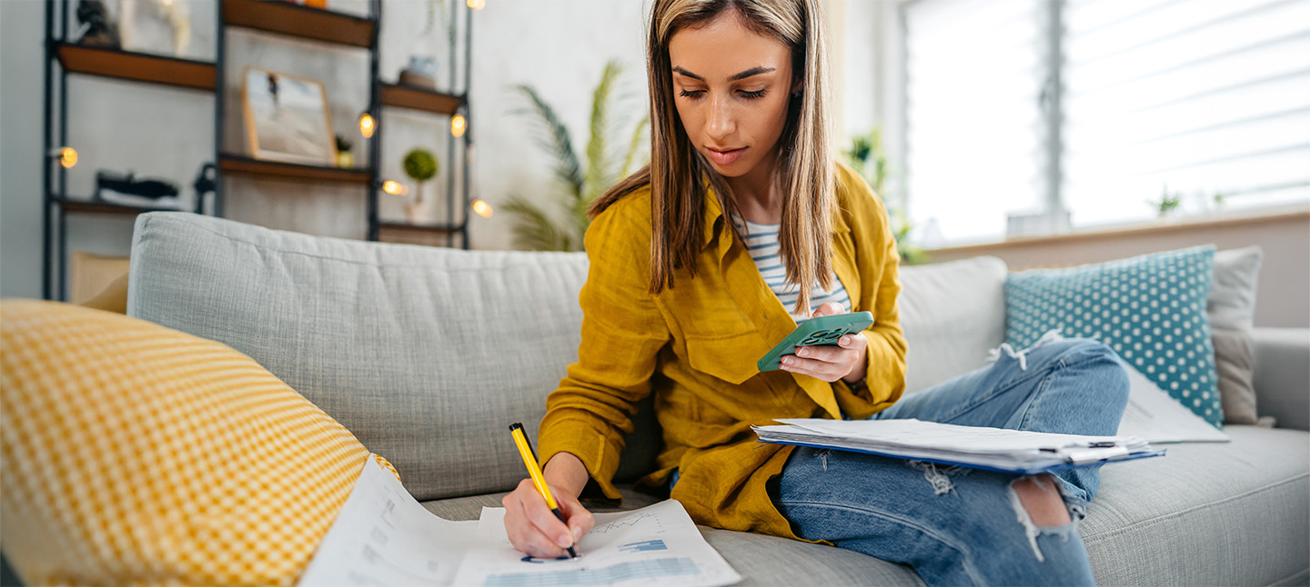 Young Woman Checking Her Finances Using Smartphone